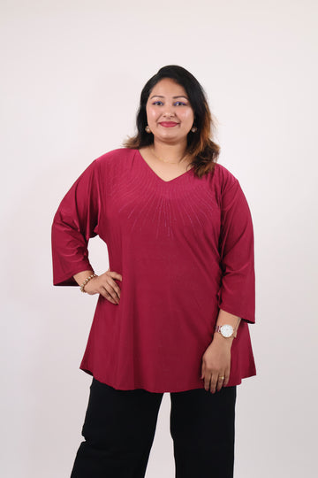 Person wearing a red top and black pants on a white background